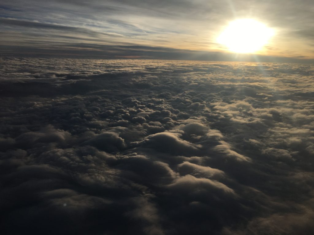 Image taken from the airplane, flying above the clouds