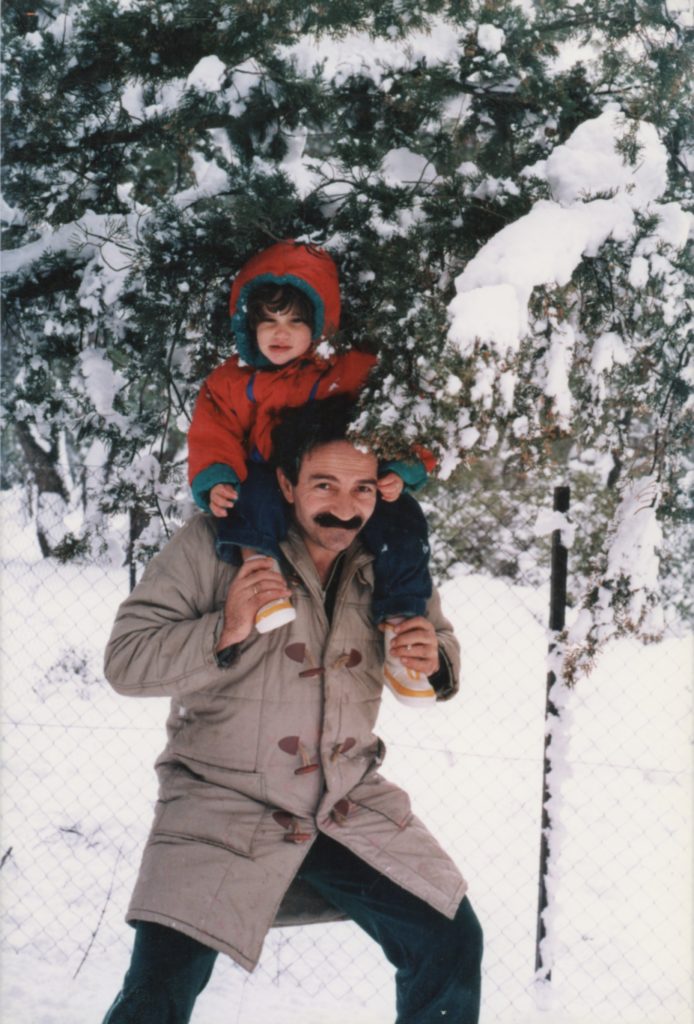 Christianna on dad's shoulders in the snow